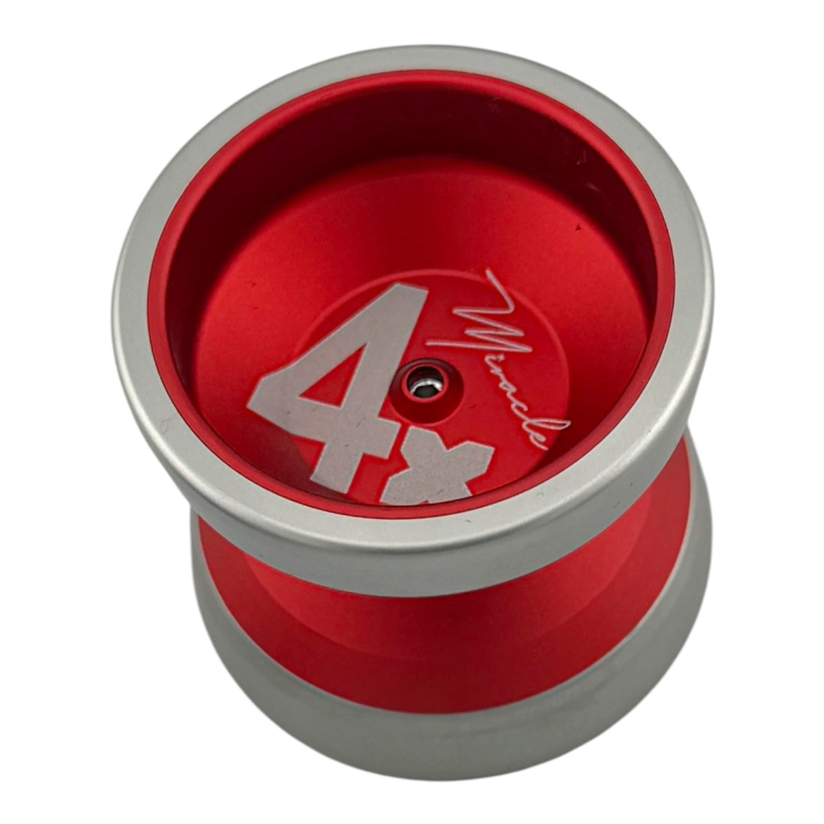 Miracle MINI YoYo 4x - A red and silver metal yo-yo with a large silver '4x' and a signature-style logo on the inner plate, shown on a plain white background.