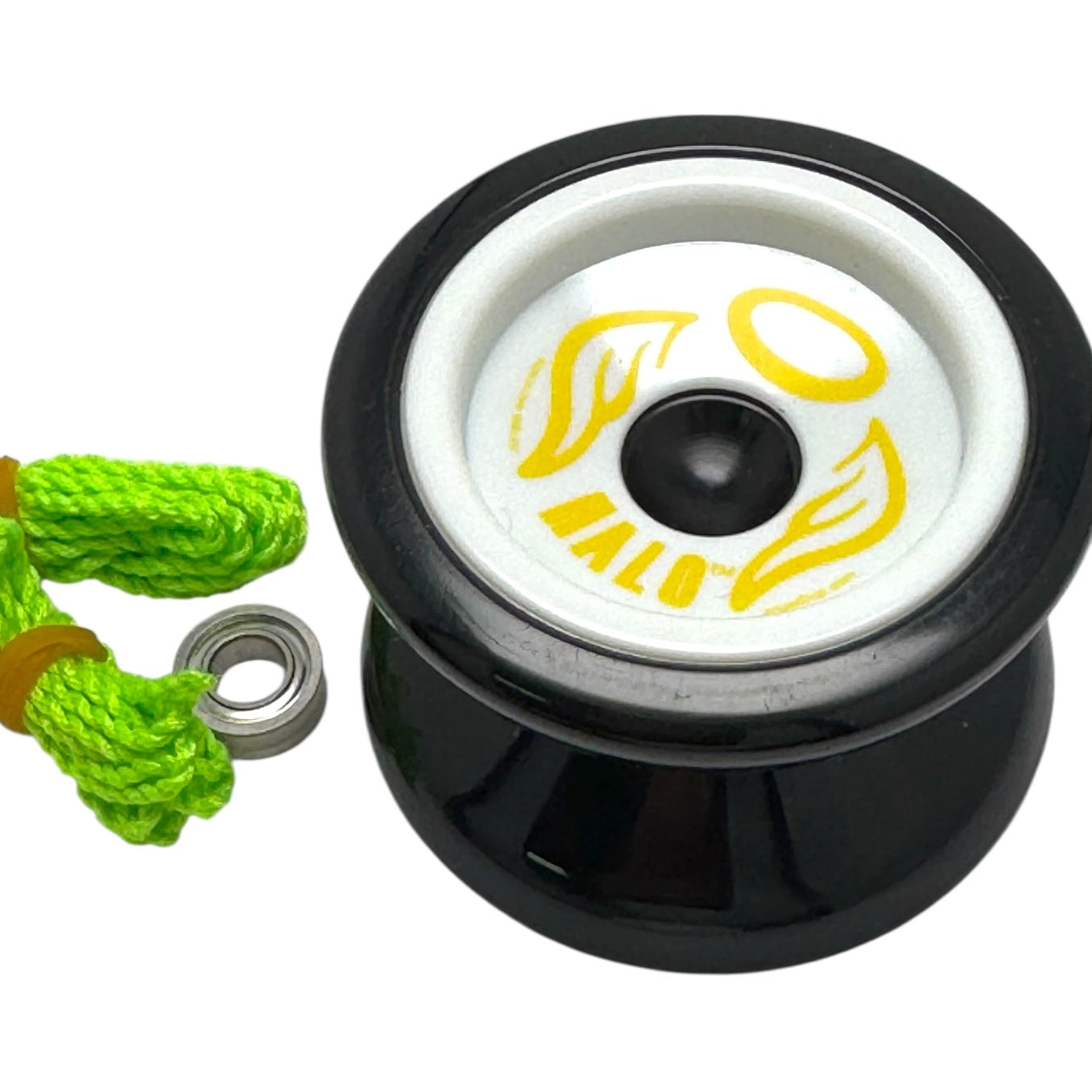 Black and white Halo yoyo with green string on a white background