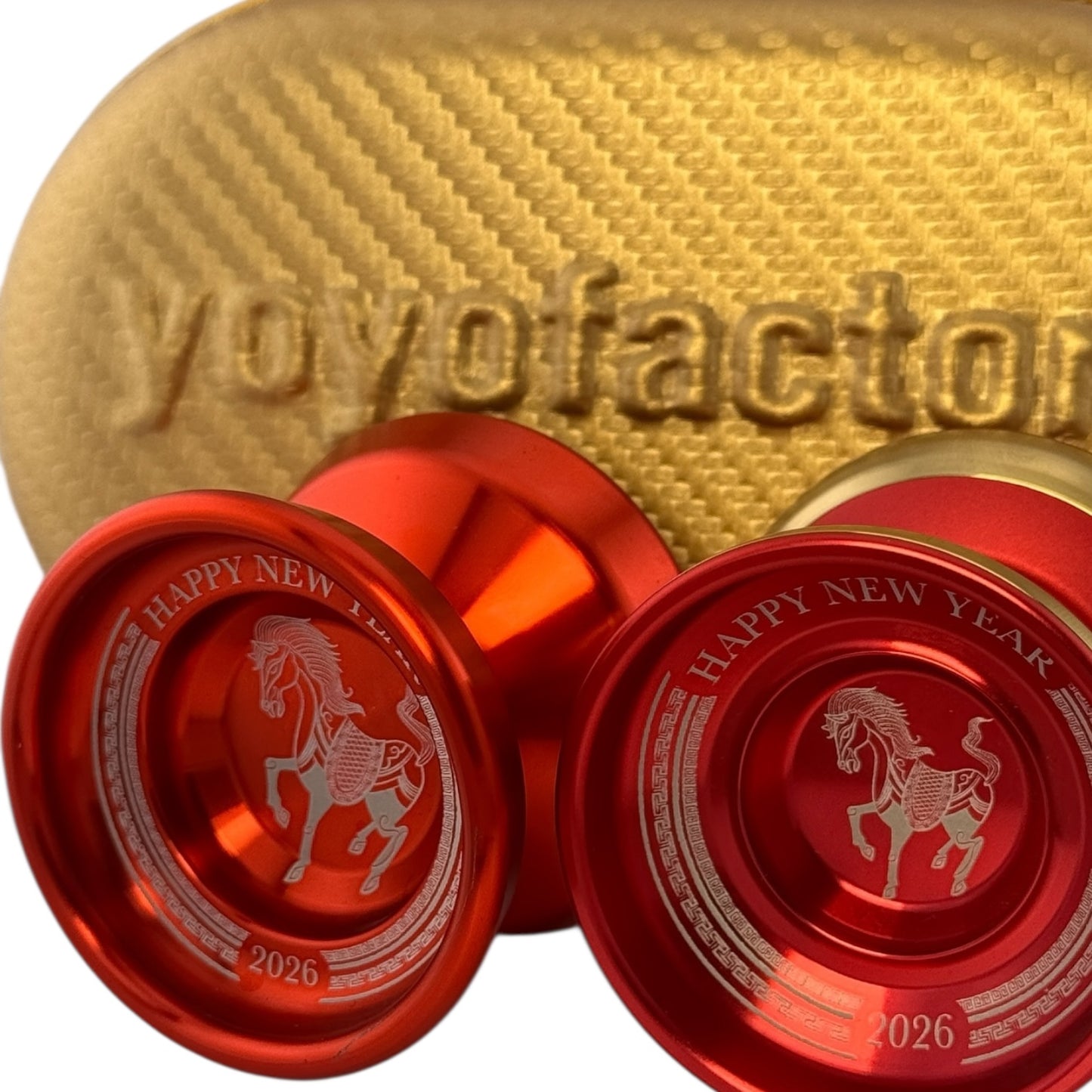 Red yoyos with horse design and 'Happy New Year 2026' text on a gold yoyo with 'yoyofactory' branding.