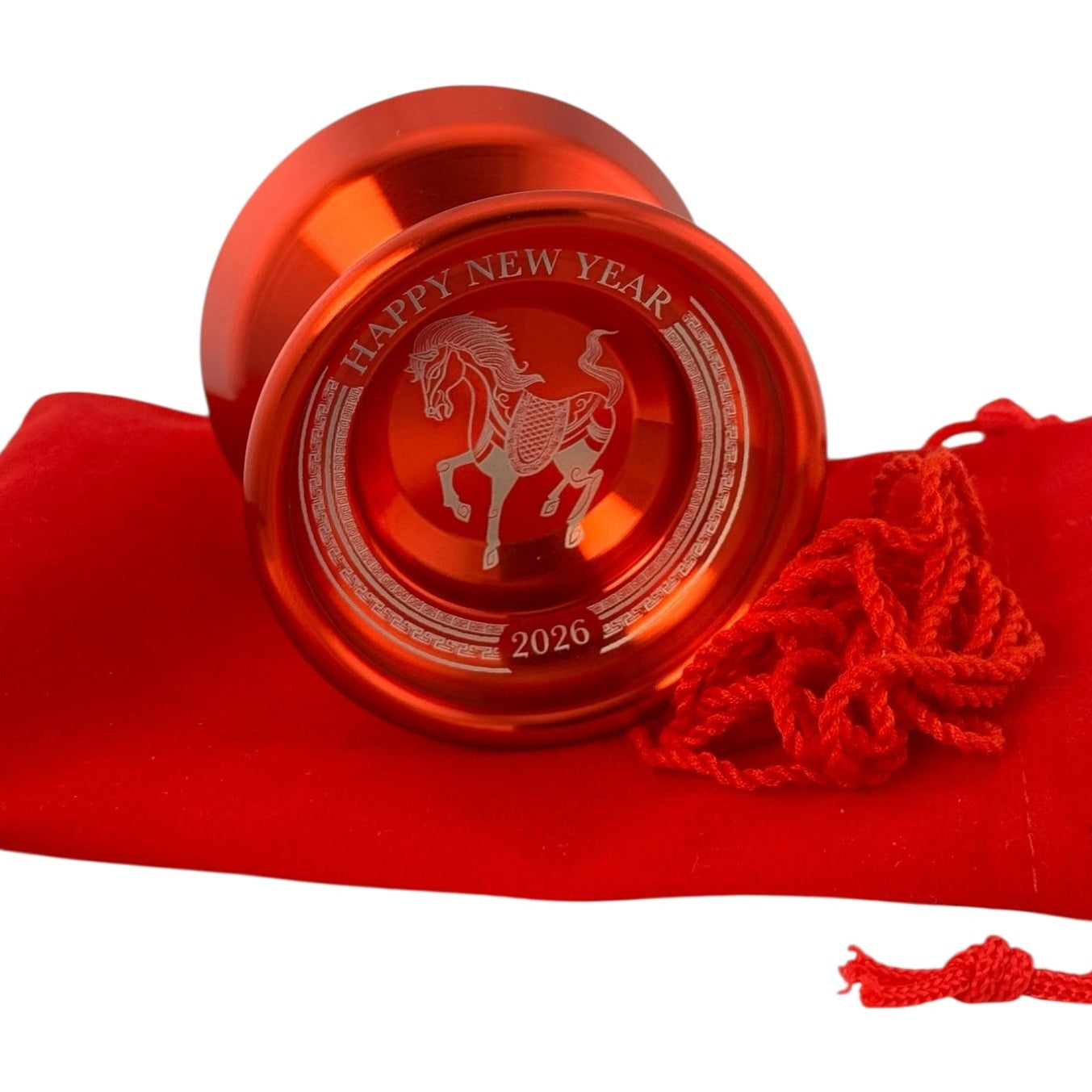Red yoyo with 'Happy New Year' and horse design on a red cloth background