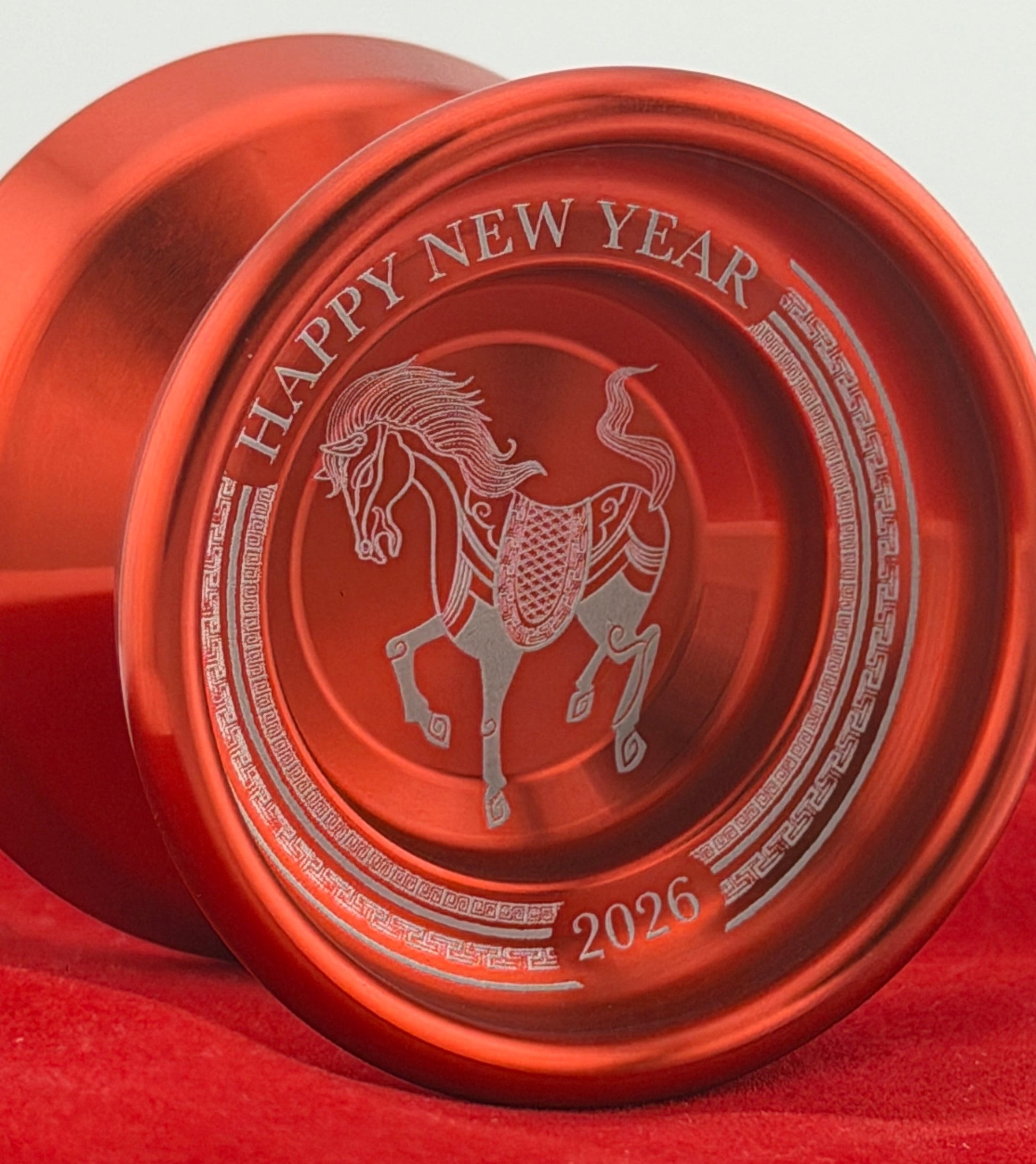 Red yoyo with 'Happy New Year' and horse design on a red background