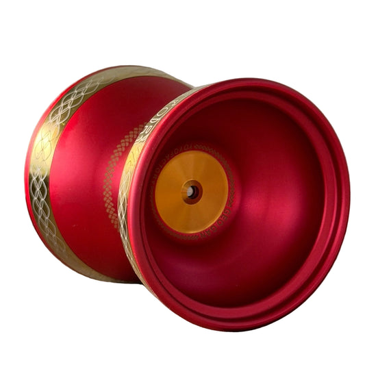 Starlight plus red and gold yo-yo with a patterned gold band.