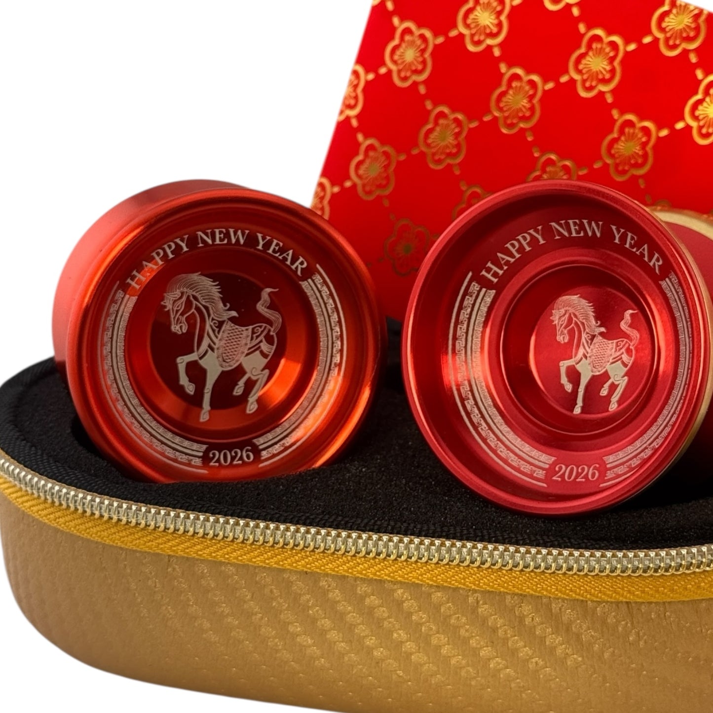 Two red 'Happy New Year 2026' yoyos with a horse design in a black and gold case.