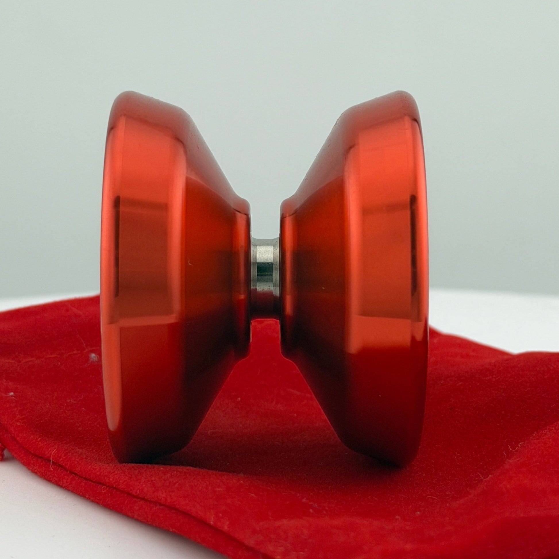 Red yoyo on a red cloth with a white background